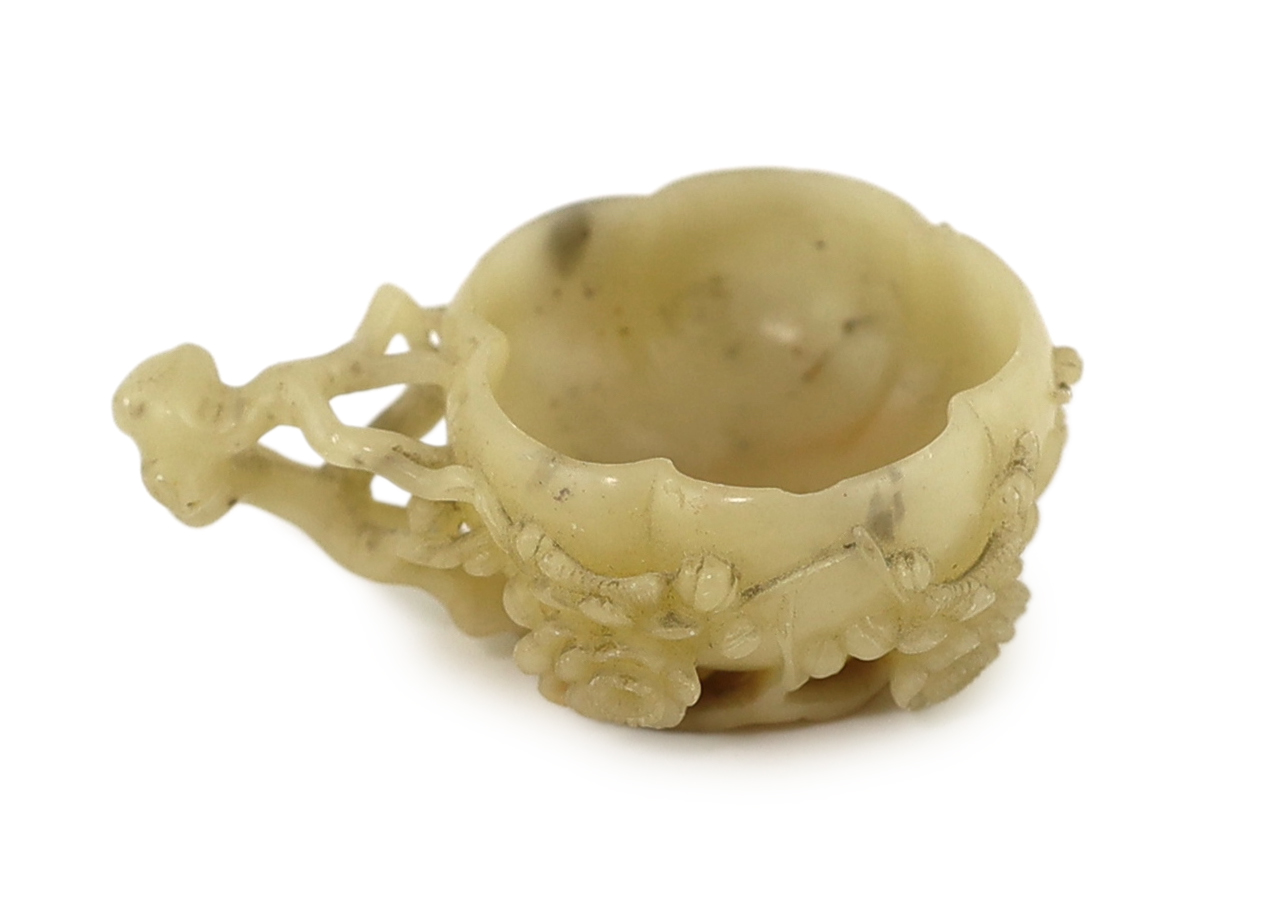 A Chinese creamy white soapstone ‘plum blossom’ cup, 18th/19th century, carved in high relief and open work with prunus branches and blossom, the stone of creamy white tone with some pale russet inclusions, 7.4cm across